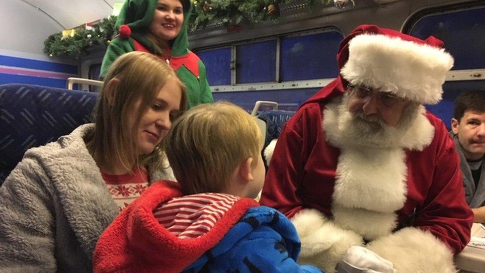 Family meeting Father Christmas on a train