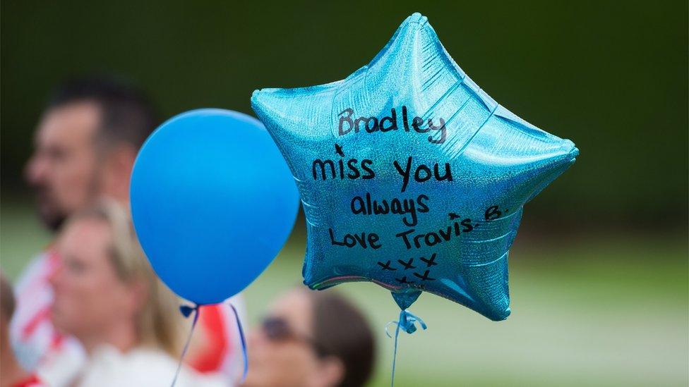 A balloon with a message reading "Bradley, miss you always, love Travis"