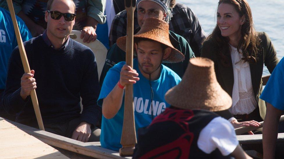 The Duke and Duchess of Cambridge, sit on a First Nations canoe after paddling to shore with members of the Haida First Nation in Haida Gwaii, British Columbia on September 30, 2016.