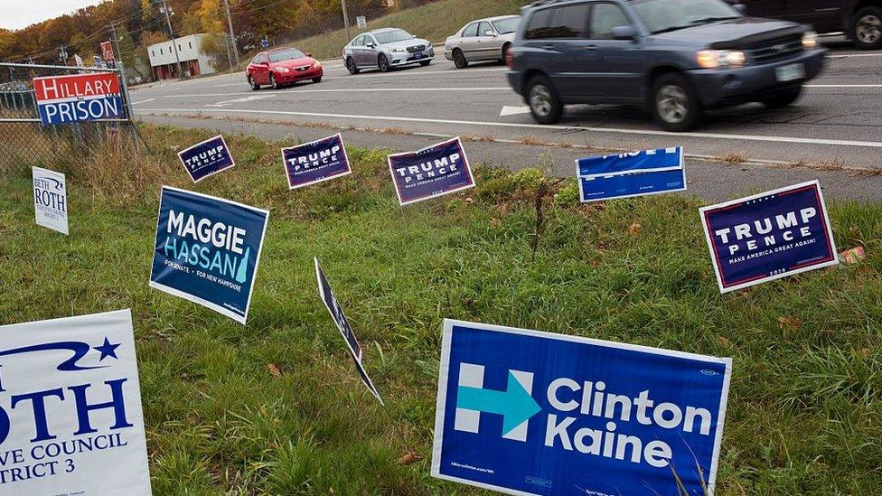 Motorist pass by campaign signs n Salem, New Hampshire