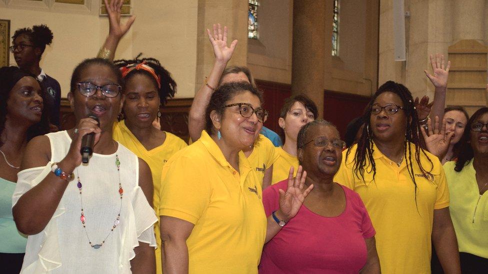 Singers smiling on stage as they perform