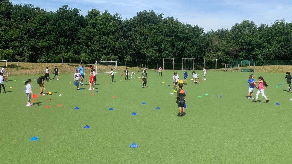 Children playing outside on the field