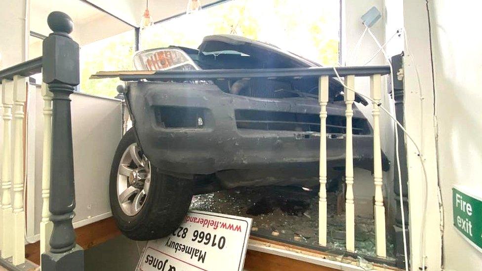 Malmesbury shopfront with car in it