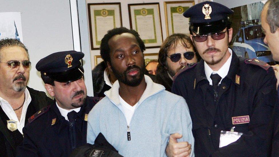 Rudy Guede, centre, arriving at Rome's Fiumicino airport in 2007 after his extradition from Germany