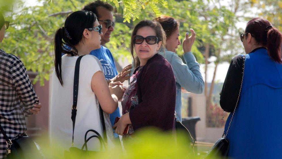 Relatives of passengers on a vanished EgyptAir flight grieve as they leave the in-flight service building where they were held at Cairo International Airport, Egypt, Thursday, 19 May 2016.