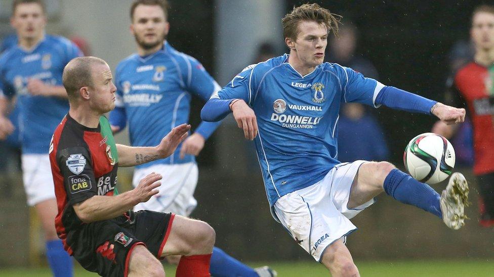 Barry Holland of Glentoran in action against Paul McElroy who scored twice in Dungannon's 3-1 home win over Glentoran