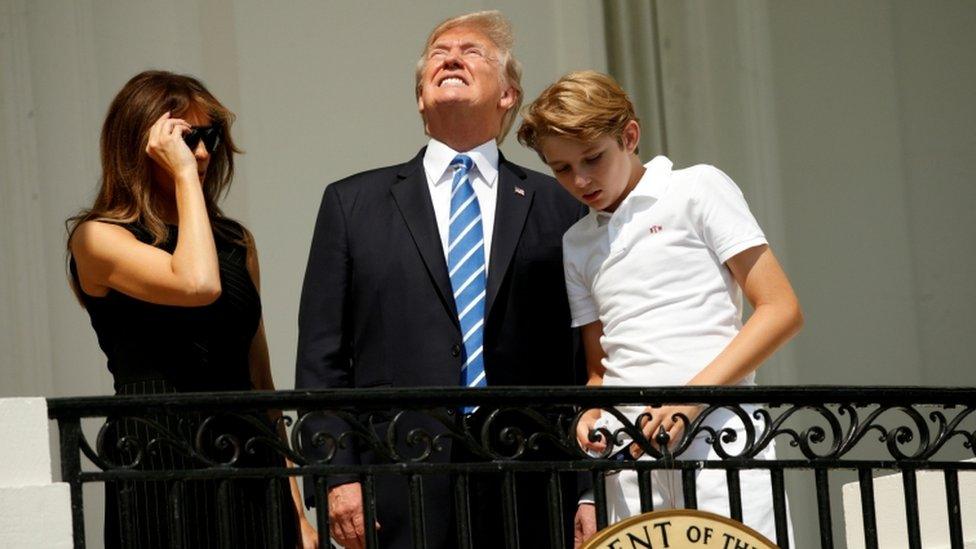 Trump looks at the eclipse