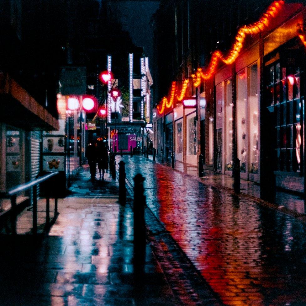 An image of a street emblazoned with lights