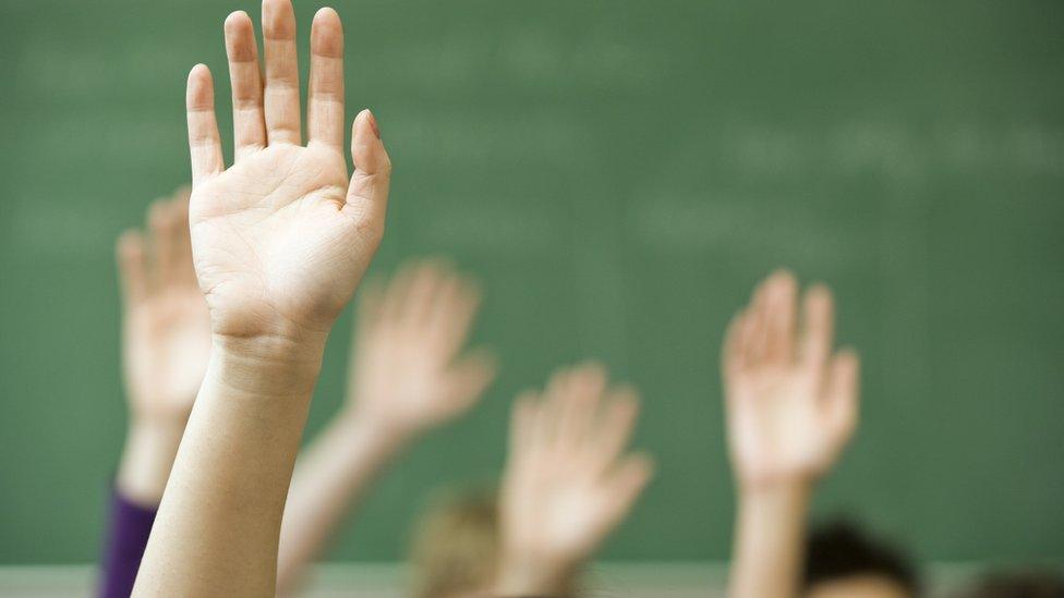 Hands up in a classroom