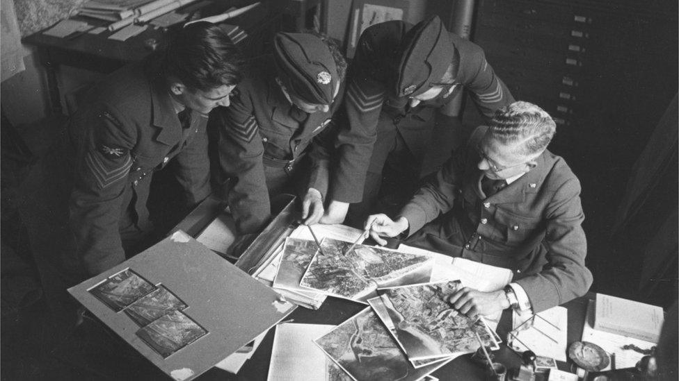 September 1941: Airmen studying reconnaissance photos during WW II. Original Publication: Picture Post - 872 - Photo Reconnaissance - unpub. (Photo by Bert Hardy/Picture Post/Hulton Archive/Getty Images)