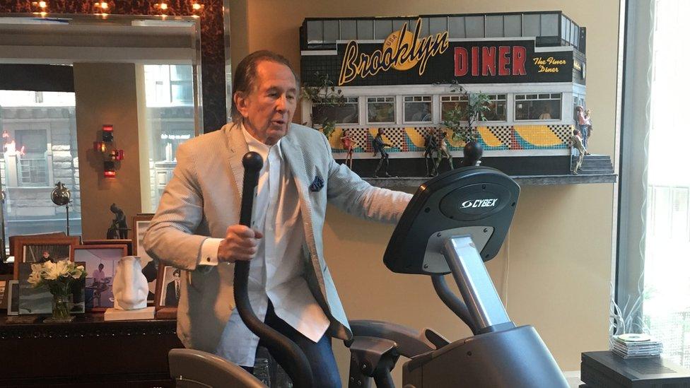 Shelly Fireman on exercise machine in his office