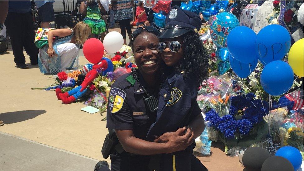 Police officer with small child, Dallas (10 July)