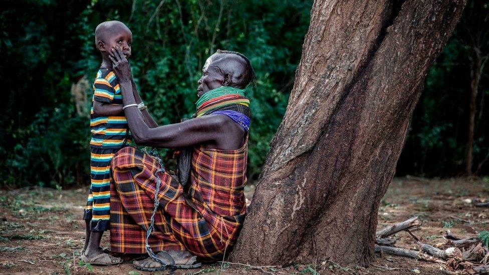 Woman removes dirt from her son's face on Friday 4 October 2019