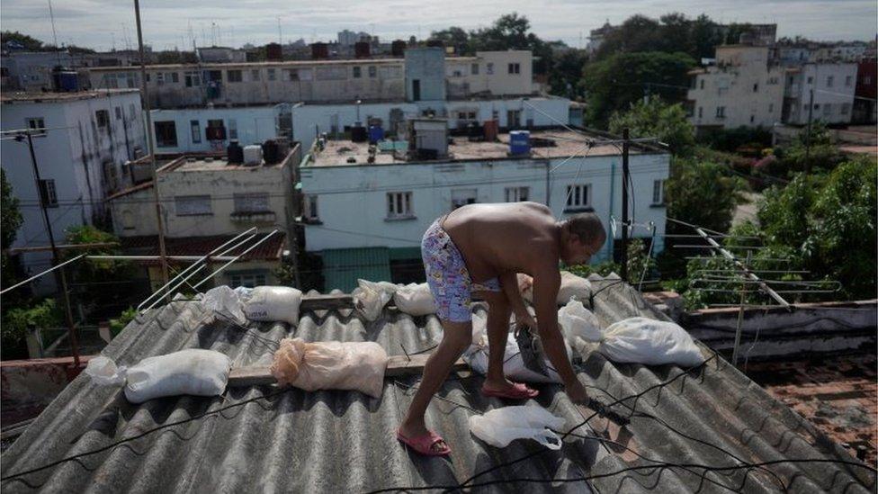 A man makes preparations for the arrival of the hurricane