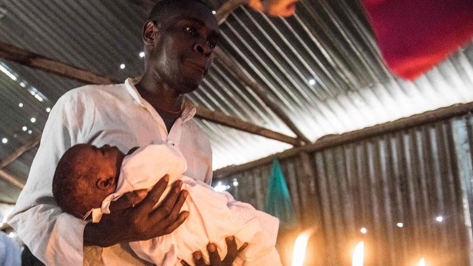 A man holding a baby