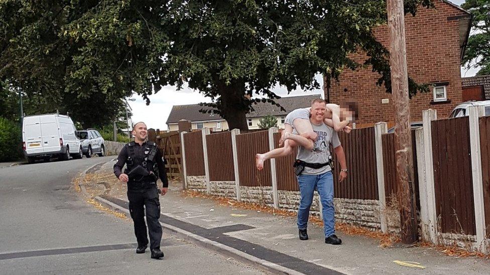 Williams being carried by an officer