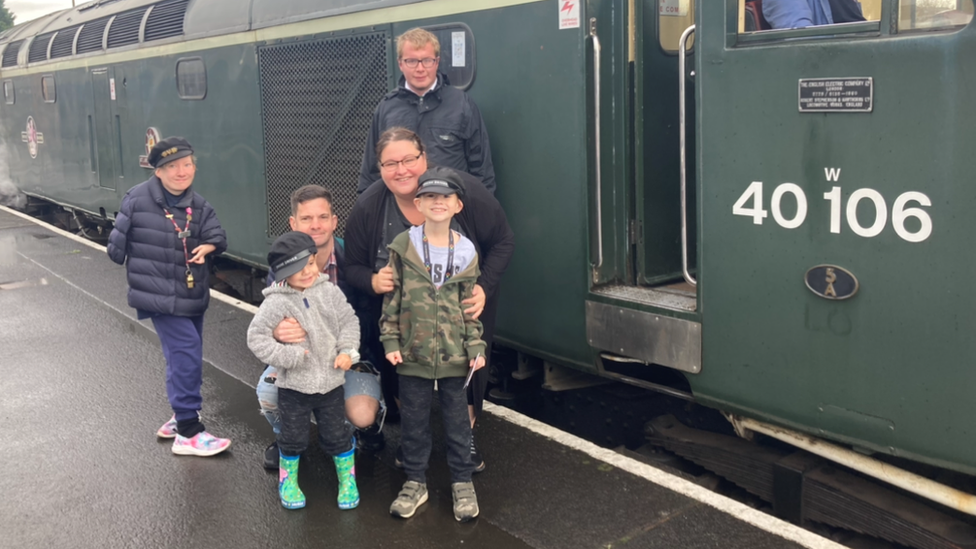 Corey beside a train