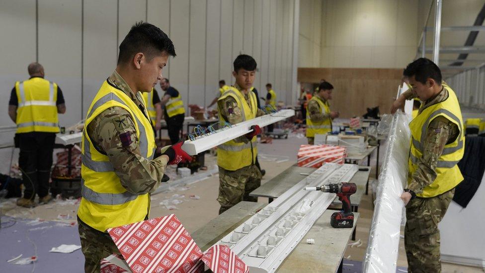 The military and contractors build the Nightingale Hospital at the Excel in London for Covid-19 patients