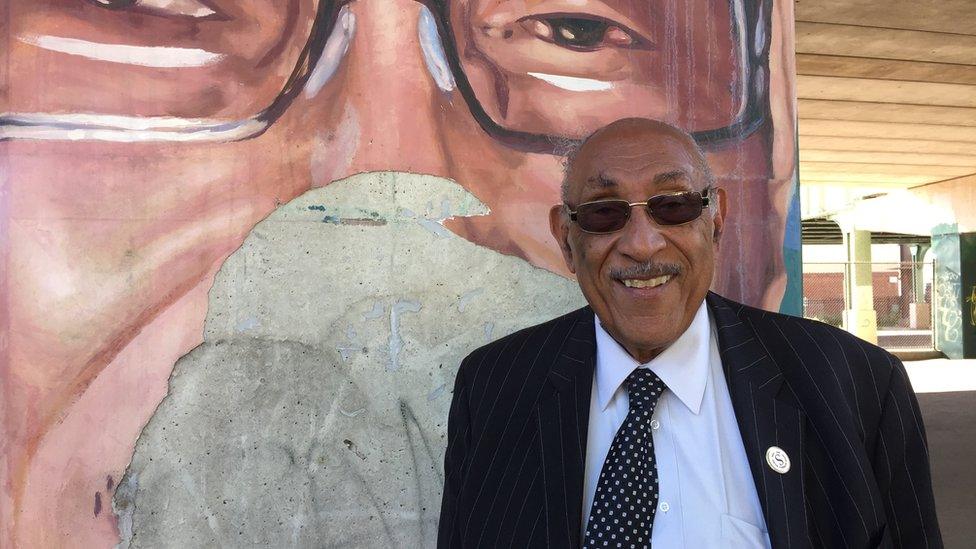 William "Buddy" Savin stands near a crumbling mural of himself in North Philadelphia's Poplar neighbourhood