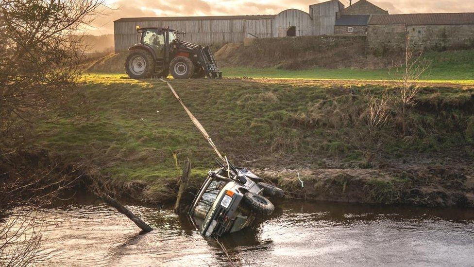 The recovered vehicle being removed from the River Esk near Glaisdale