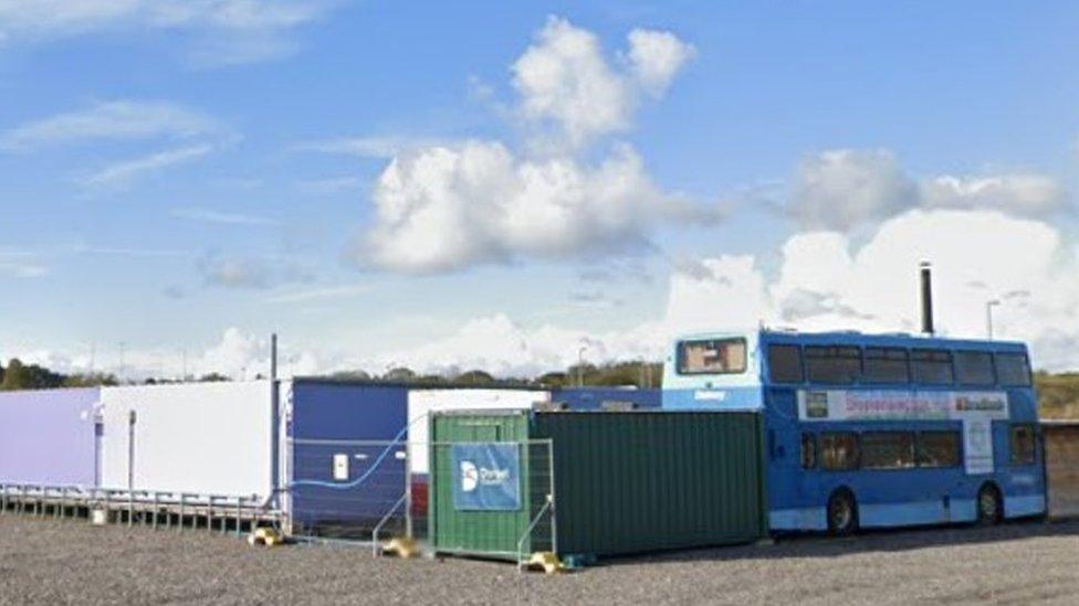 A bus and shipping containers