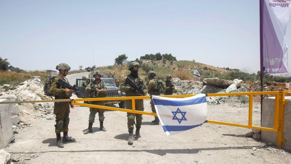 File photo showing Israeli soldiers guarding an entrance to the site of the evacuated settlement of Homesh (27 May 2022)