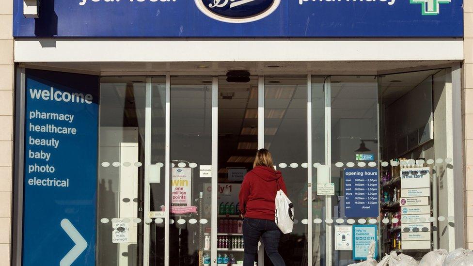 A sign is pictured above the entrance to a branch of Boots pharmacy in the town centre of Darlington, northern England on September 6, 2018