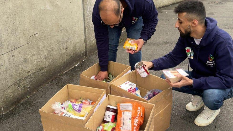 Charity volunteers packing boxes of food