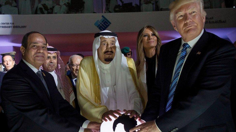 Egypt's Sisi, Saudi King Salman and Donald Trump pose with their hands on a globe