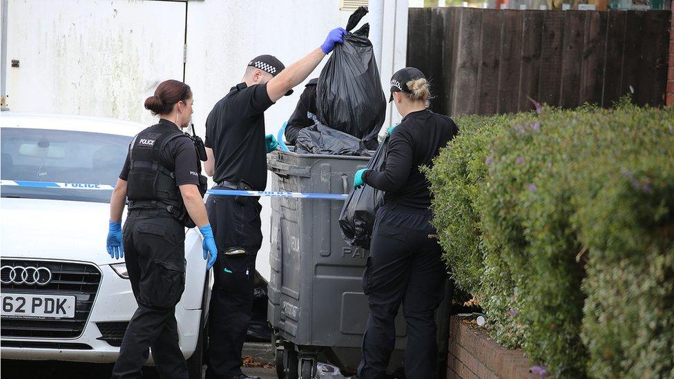 Police inspecting bins