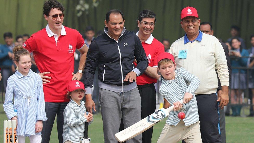 Hadrien sticking his tongue out at his brother Xavier while playing cricket