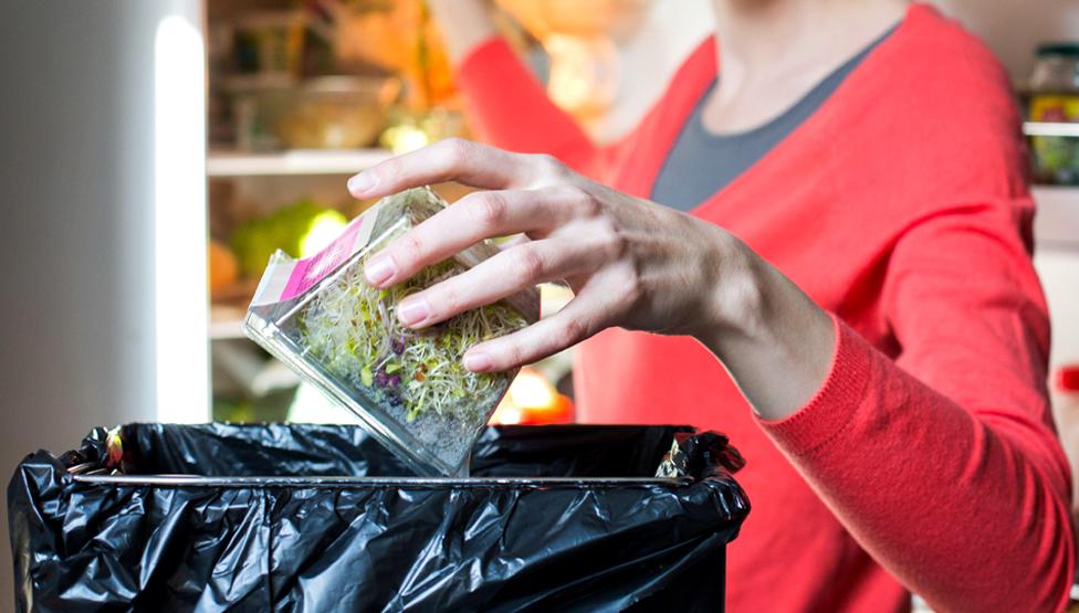 Woman throwing food away