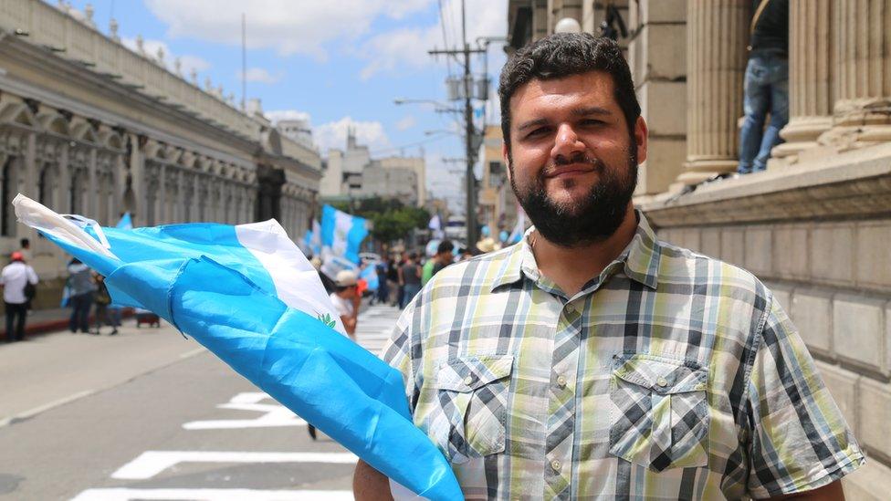 Protester Gabriel Wer holds a flag in Guatemala City - September 2015