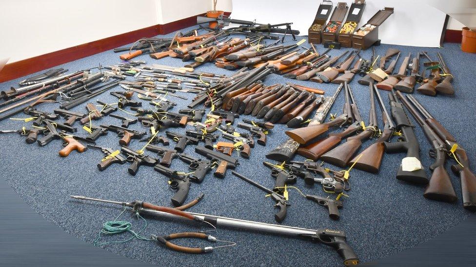 Weapons handed in laid out on the floor