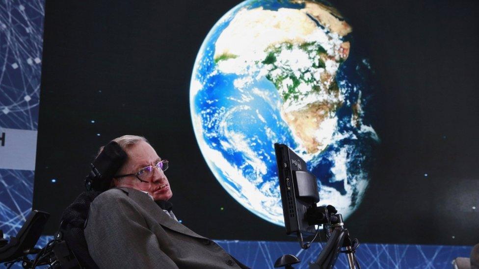 Physicist Stephen Hawking sits on stage during an announcement of the Breakthrough Starshot initiative with investor Yuri Milner in New York