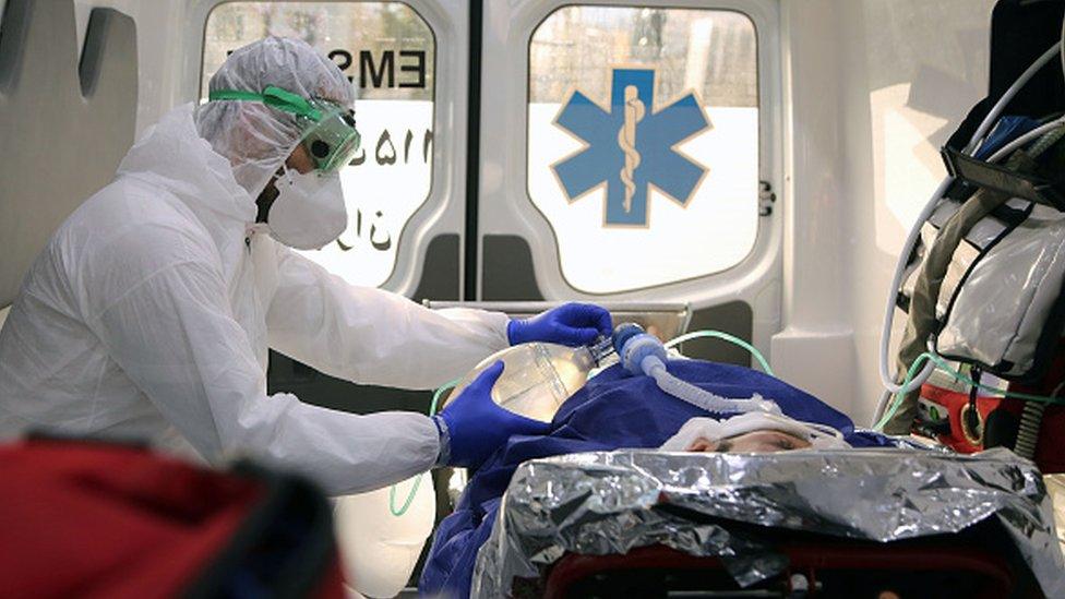 Ambulance staff arriving with a patient at a hospital in Iran