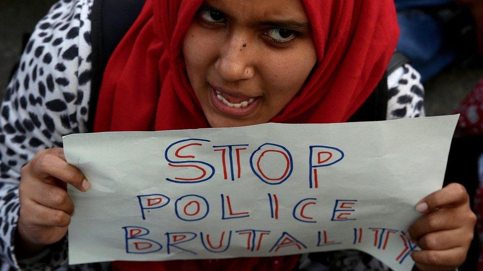 An Indian protester holds a placard during a protest in solidarity with Jamia Millia Islamia University students and against the Citizenship Amendment Bill (CAB) and National Register of Citizens (NRC), in Bangalore, India,