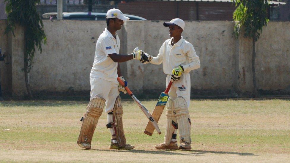 Pranav Dhanawade celebrates with a team mate during a record innings