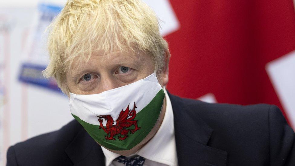 Boris Johnson in a Covid mask with Welsh dragon picture