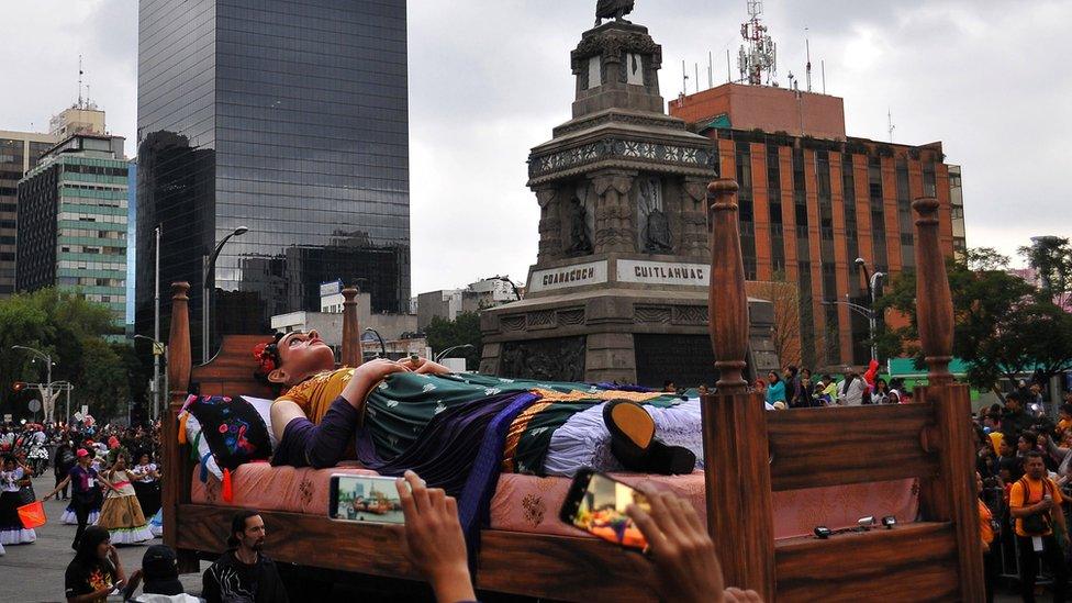 A large parade float of Frida Kahlo