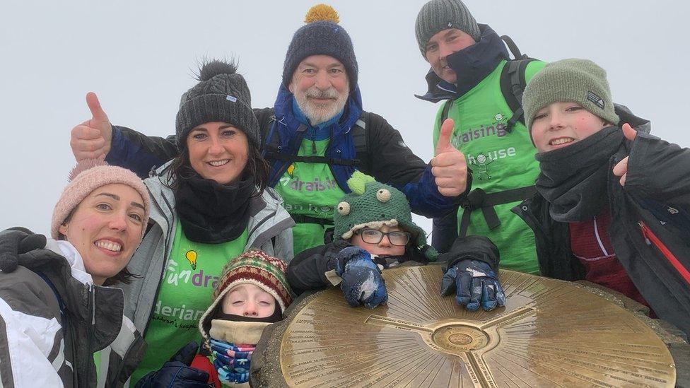 Oscar Burrow and family at the foggy summit