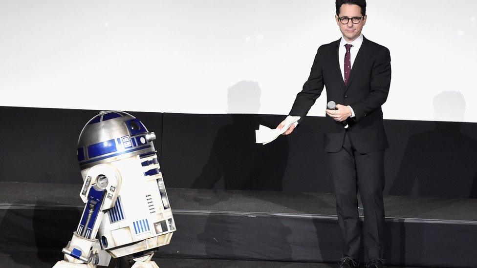 R2-D2 (L) and director J.J. Abrams speak onstage the World Premiere