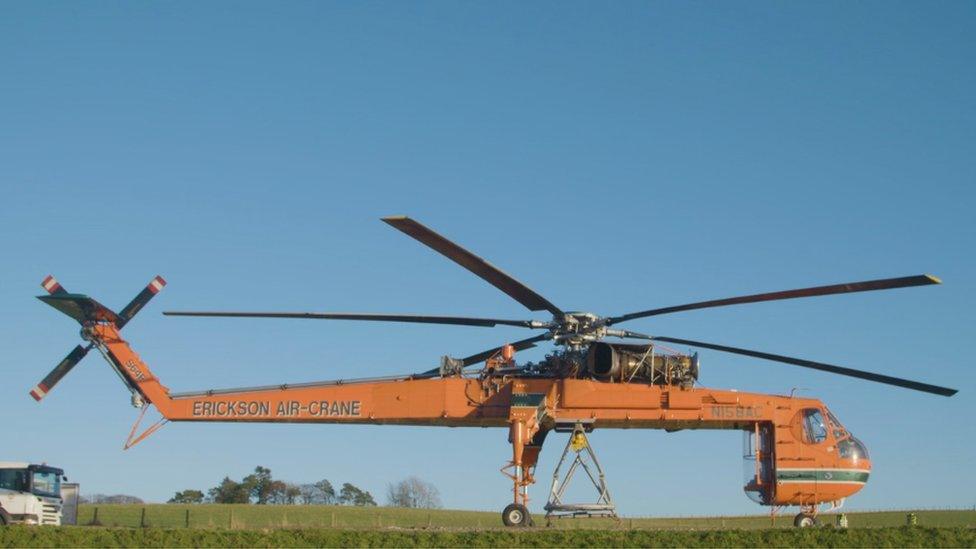 Helicopter and electricity towers