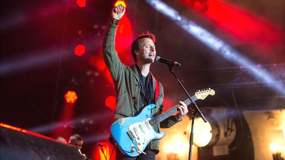 Chesney Hawkes on stage with guitar