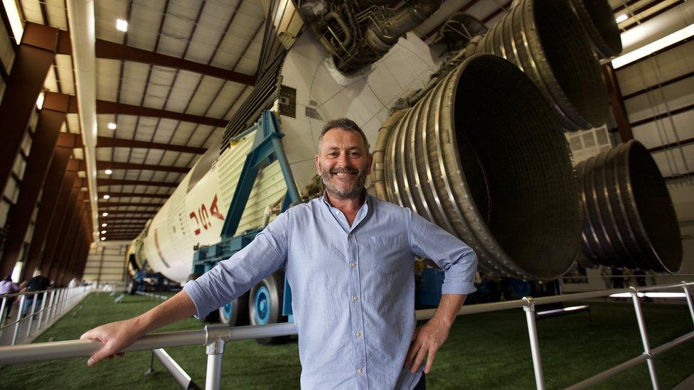 Tudur Owen in front of rocket