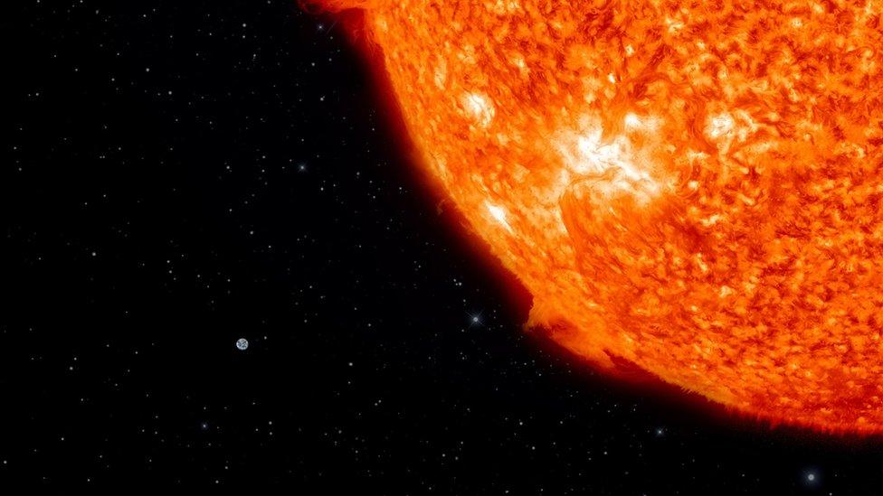 A size comparison showing how small the Earth is compared to the Sun.