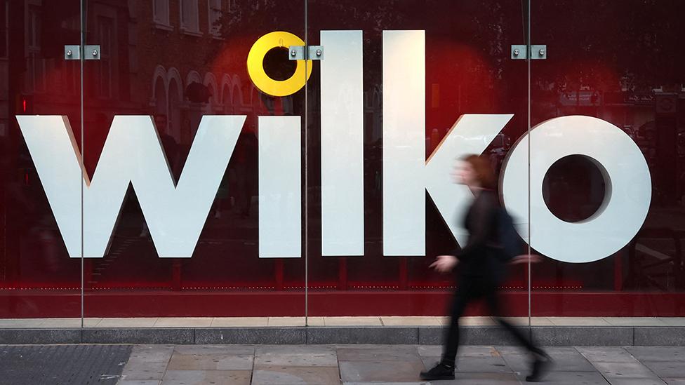 A person walks past a Wilko store