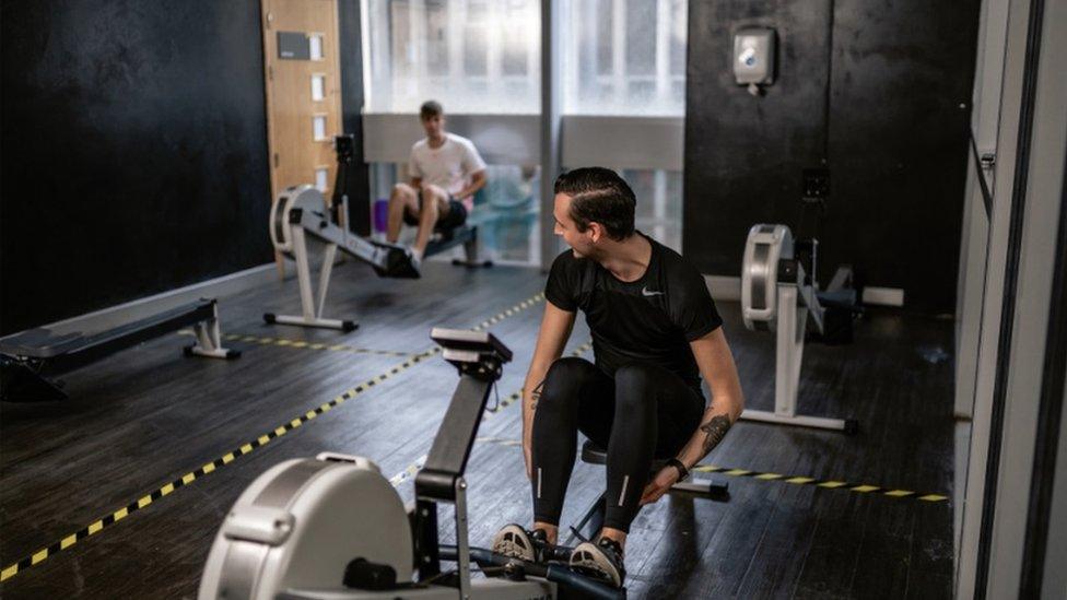 Two men using gym equipment