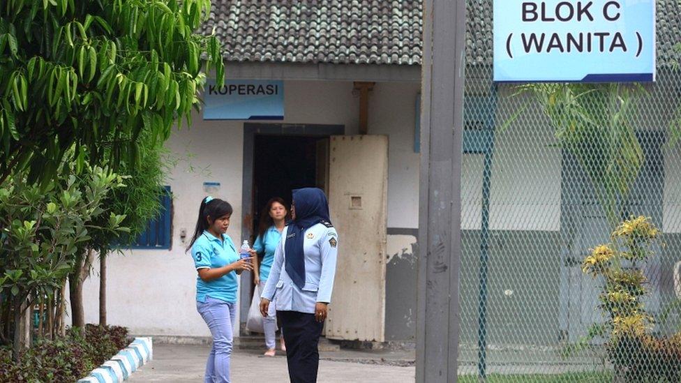 A drug convict (L) speaks to an Indonesian official at a prison in Yogyakarta