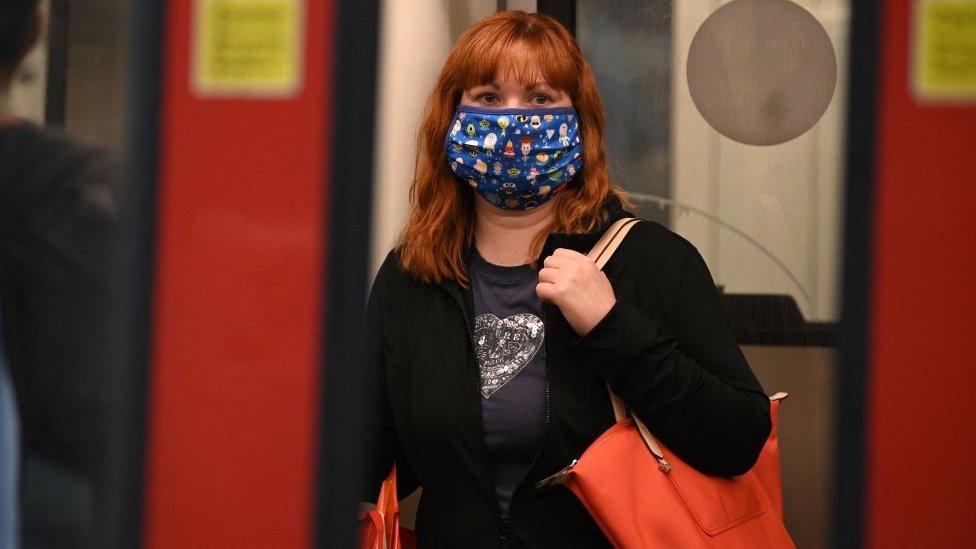 Woman commuting and wearing a mask